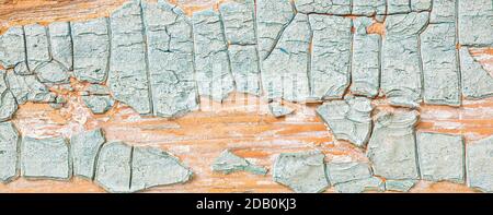 Texture of thick cracked layer of light blue paint on old wood Stock Photo