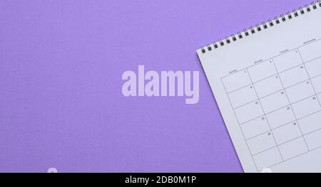 Calendar on purple background. Top view. Copy space. Stock Photo