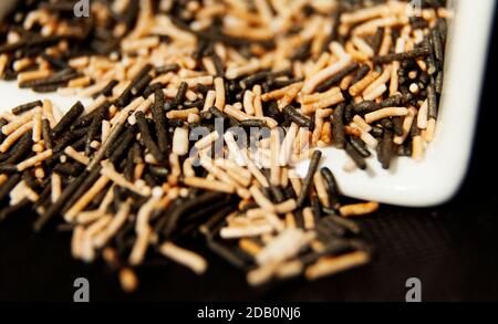 sprinkles poured from a white bowl Stock Photo