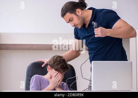 Father and schoolboy playing computer games at home Stock Photo