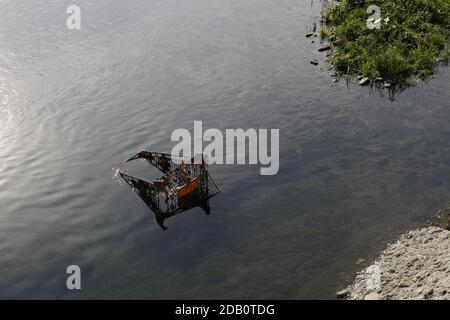 Abandoned shopping trolleys left behind in water way Stock Photo