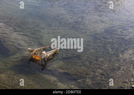 Abandoned shopping trolleys left behind in water way Stock Photo