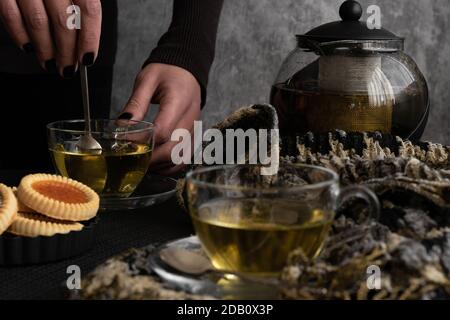 Woman hands pouring tea from  a teapot Stock Photo