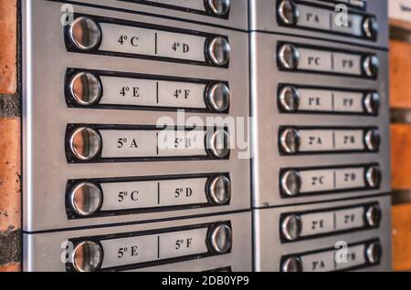 Closeup on the buttons of an intercom in the entrance of an apartment building. Selective focus on the foregound. Stock Photo