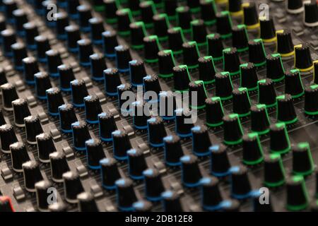 Buttons and knobs to adjust a mixer for music and sound processing Stock Photo