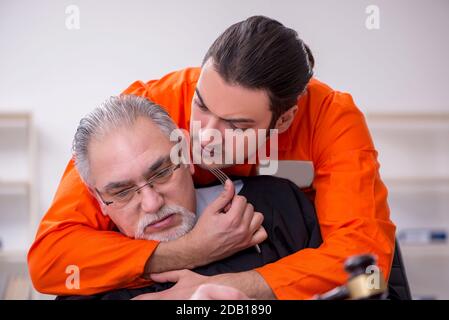 Old judge meeting with young captive in courthouse Stock Photo