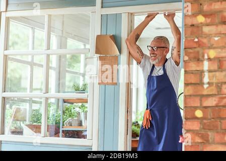 Middle aged caucasian man standing with raised hands Stock Photo
