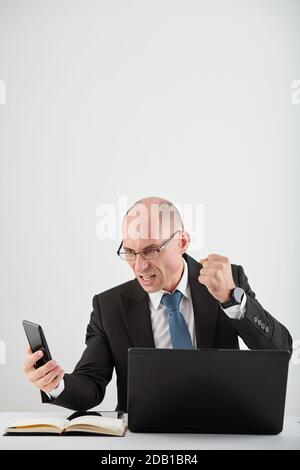 Angry entrepreneur with smartphone Stock Photo