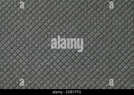 Texture of dark gray fluffy fabric background with rhomboid pattern, macro. Abstract backdrop from decorative black woven textile material. Stock Photo