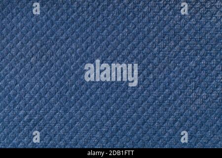 Texture of navy blue fluffy fabric background with rhomboid pattern, macro. Abstract backdrop from decorative denim woven textile material. Stock Photo