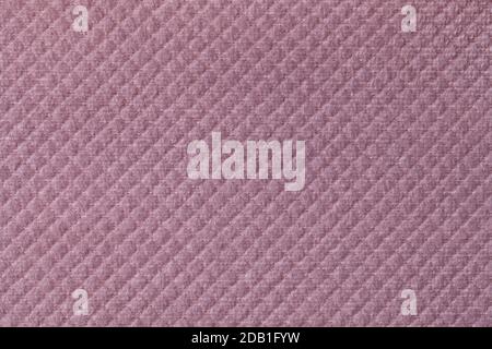 Texture of light purple fluffy fabric background with rhomboid pattern, macro. Abstract backdrop from decorative pink woven textile material. Stock Photo