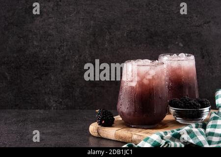 Fresh blackberry cocktail in cold glass on black stone Stock Photo