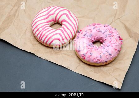Two pink donuts on a dark background Stock Photo