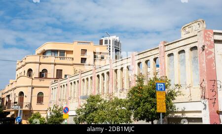 TEL AVIV, ISRAEL - MARCH 7, 2019: Abandoned old Eden Cinema building renovated house and modern skyscraper at background in Neve Tzedek district. Stock Photo