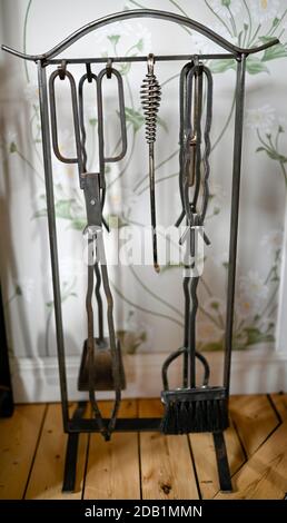tools for fireplace hanging on stand indoors Stock Photo