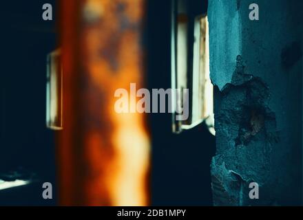 Destroyed room in abandoned building. Sun rays light up messy apocalyptique interior. Decay concept. Toned photo. Stock Photo
