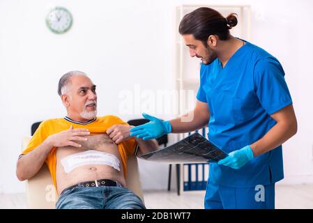 Old man visiting male doctor Stock Photo