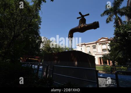 Giant Magic Tap, an outdoor floating tap fountain hovering above a pool, with endless supply of water gushing out of it, seemingly from nowhere, this Stock Photo