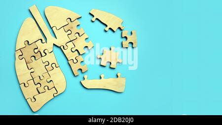 Damaged lungs from puzzle pieces. Respiratory tract disease. Stock Photo