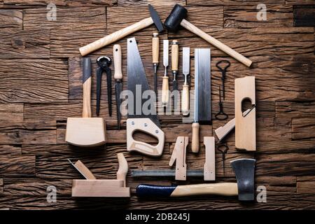 Various Carpenter Tools In House Shape Laying On Desk Stock Photo