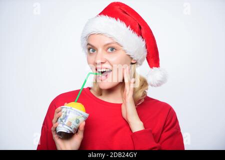 Totally natural lemon juice. Fresh lemonade drink with straw. Symbol of wealth and richness. Girl with lemon and money. Lemon money concept. Girl santa hat drink juice lemon wrapped in banknote. Stock Photo