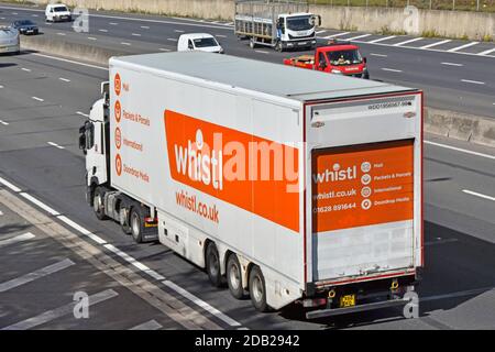 Advertising on back & side view from above lorry truck & trailer driving on motorway operated by whistl post mail delivery company business UK England Stock Photo