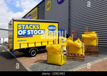 Selco builders merchant yellow delivery van with curtain side access parked at Chelmsford warehouse depot beside fibc jumbo bags Essex England UK Stock Photo
