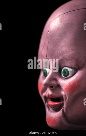 Creepy doll head in the dark Stock Photo