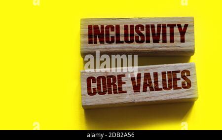 Inclusivity and core values words written on wooden blocks. Social and business concept Stock Photo