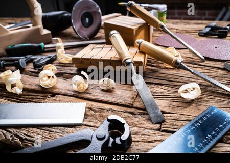 Various Carpenter Tools From Toolkit Laying On Desk Stock Photo