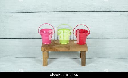 Color mini buckets on wood decor Stock Photo