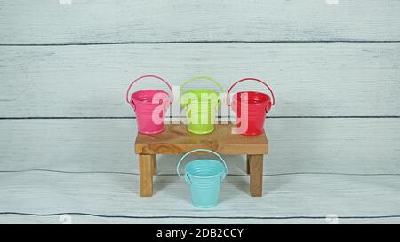 Color mini buckets on wood decor Stock Photo