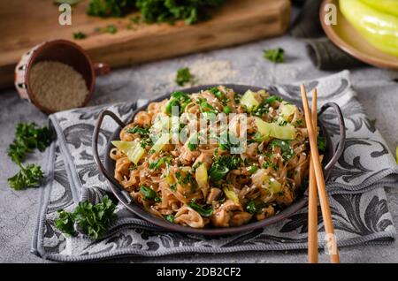 Crispy noodles with roasted chicken, fresh vegetable and soy sauce Stock Photo