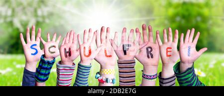 Children Hands Building Colorful German Word Schulfrei Means School Holidays. Green Grass Meadow As Background Stock Photo
