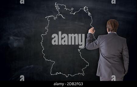 Businessman painting Germany map on blackboard concept. Stock Photo