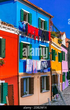 Colorful bright houses of traditional fishing village Burano near Venice. Popular touristic attraction. Italy Stock Photo