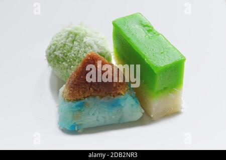 Three traditional 'Nyonya Kueh' or Peranakan (Straits Chinese) snacks. From left to right, they are 'Ondeh Ondeh', 'Pulut Inti' and 'Kueh Salat'. Stock Photo