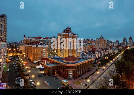 Night aerial view on Obolon area of Kyiv city with illumination. Flying drone camera shot. Stock Photo