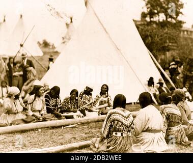 Indian women playing the stick game at the midsummer celebration on the Glacier National Park Reservation, Montana. Stock Photo