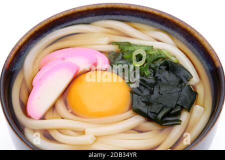 Japanese noodles in a ceramic bowl on white background Stock Photo