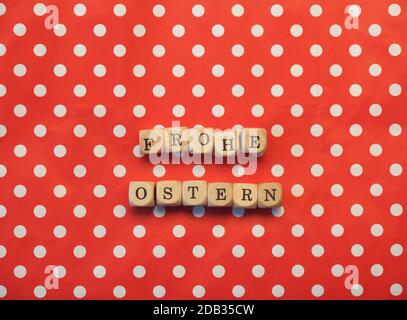 German words Happy Easter on dotted background, red background with white dots, happy holidays concept Stock Photo