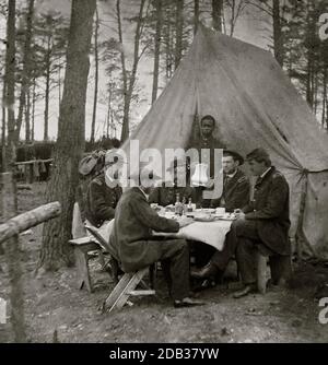 Brandy Station, Va. Dinner party outside tent, Army of the Potomac headquarters; Black Youth serves as a waiter. Stock Photo