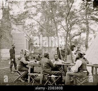 Cumberland Landing, Va. Secret Service men at Foller's House; Black seated as an equal at a table. Stock Photo