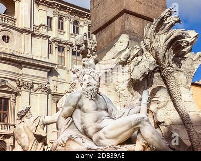 a seagull resting on the head of the statue representing the Ganges river in the Fountain of the four rivers in Piazza Navona in Rome. Travel and famo Stock Photo