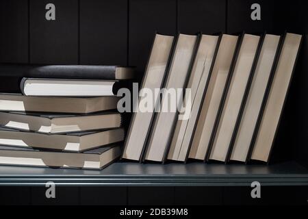 Bshelf with series of books in piles and rows Stock Photo