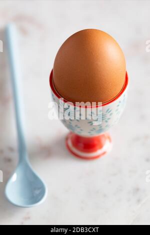 Boiled Egg in Colourful Blue and Red Egg Cup with Spoon on a White Marble Background – FOODPIX Stock Photo