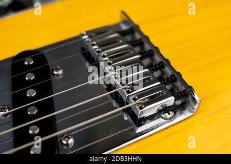 Chrome plated strings tensioners on a lacquered wood electric