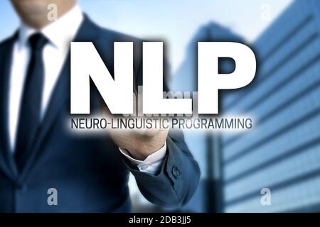 NLP touchscreen is operated by businessman. Stock Photo