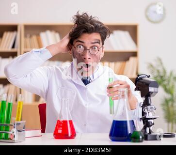 The mad crazy scientist doctor doing experiments in a laboratory Stock Photo