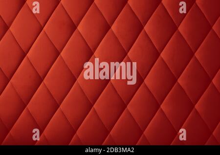 Background texture of maroon red genuine leather soft tufted furniture or wall panel upholstery with deep diamond pattern, close up Stock Photo